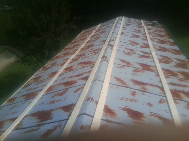 Rusted metal roof panels with new wood purlins before replacement — Storm Damage Roof Repair in Fort Bragg by Roofing Brothers